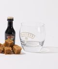 A guilt-free snack - a glass with a bottle of low-sugar No Guilt Bakes' Irish Cream Flavour Keto Fudge and some caramels, perfect for those on a keto fudge diet.