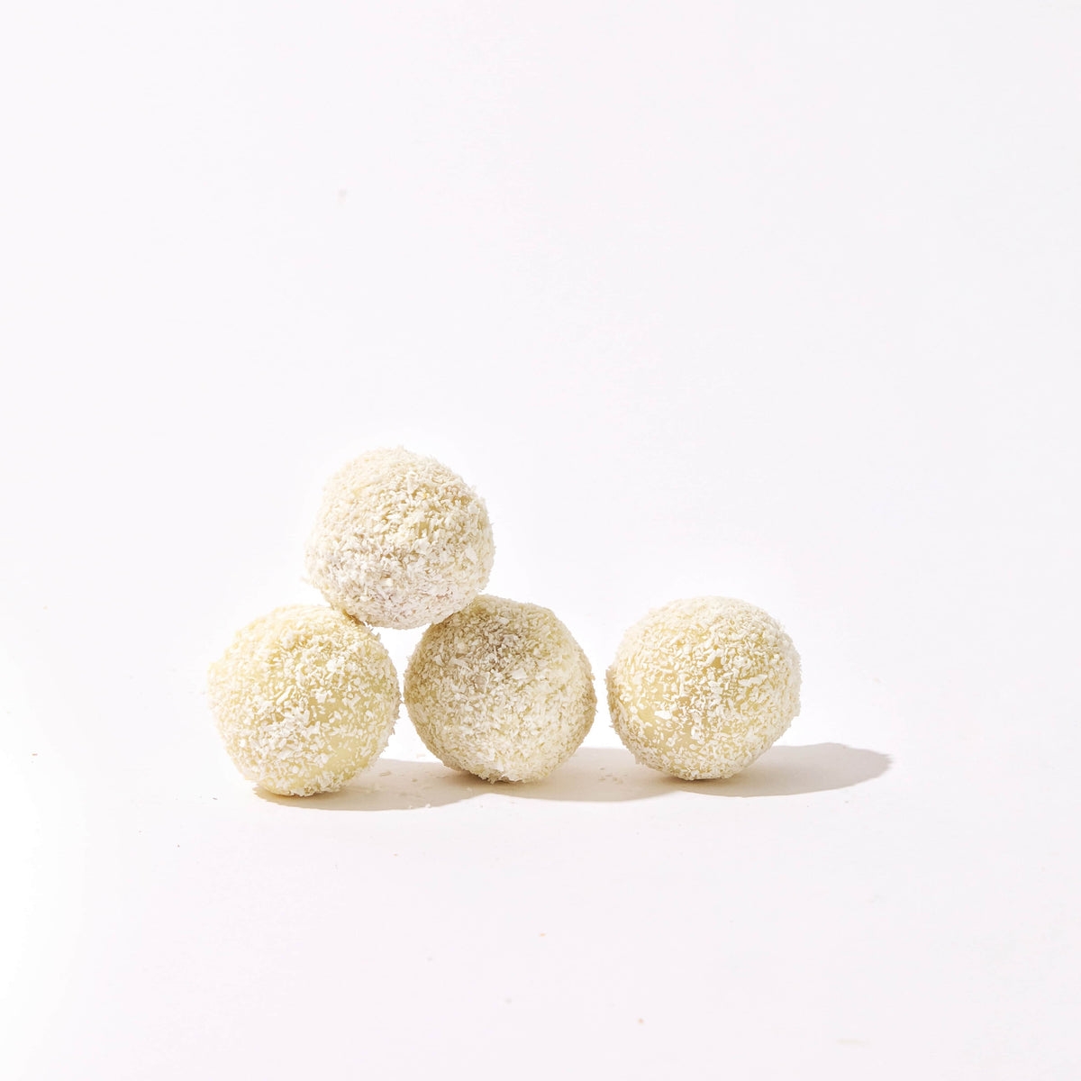 four white chocolate-covered snowballs